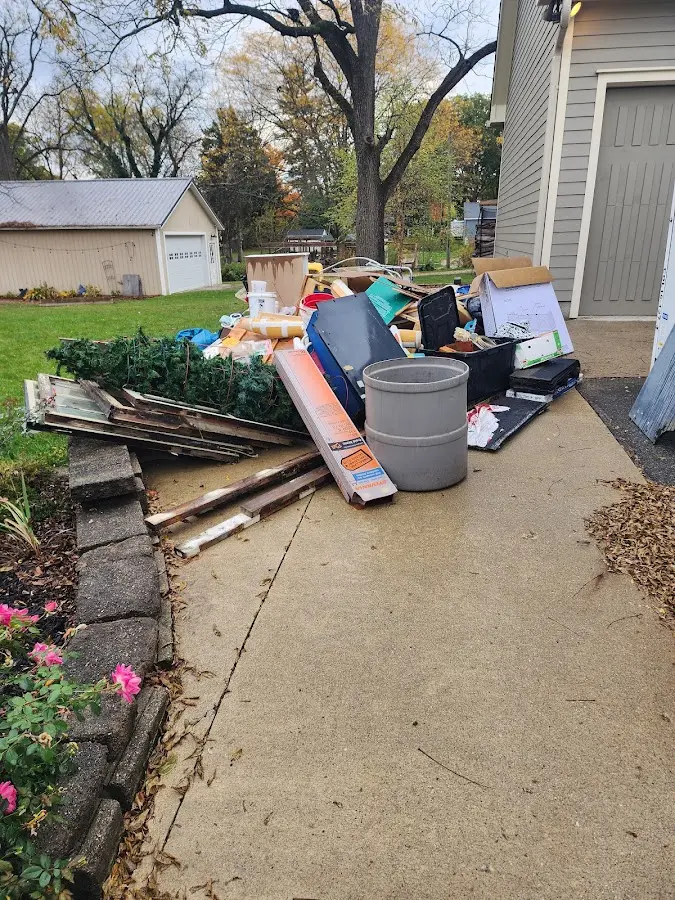 Dumpster being loaded with debris for 12 Yard Dumpster Rental in Winter Park